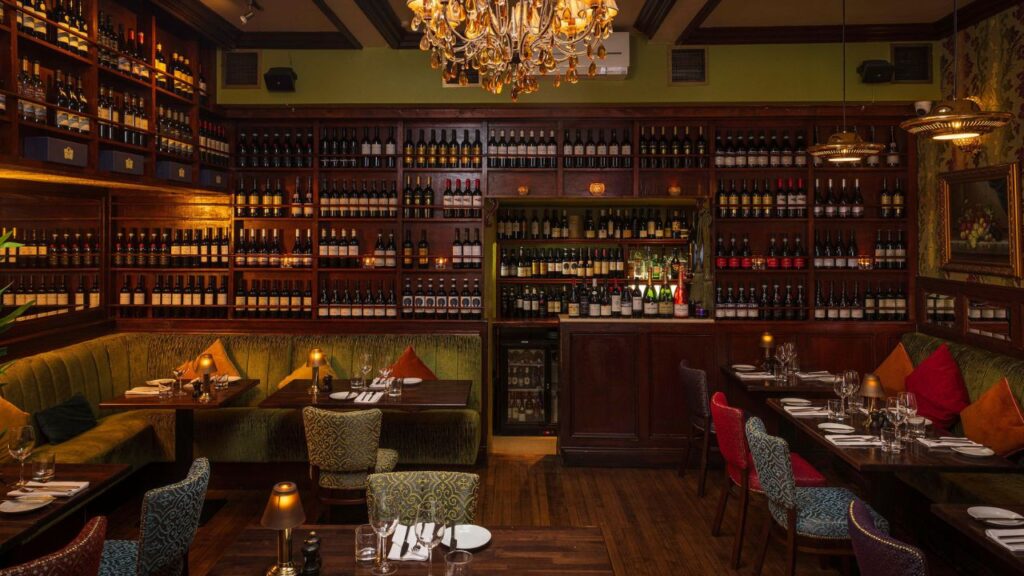 Hugo’s Restaurant interior with wine-lined walls and elegant dining tables, a popular venue for Christmas lunch in Dublin