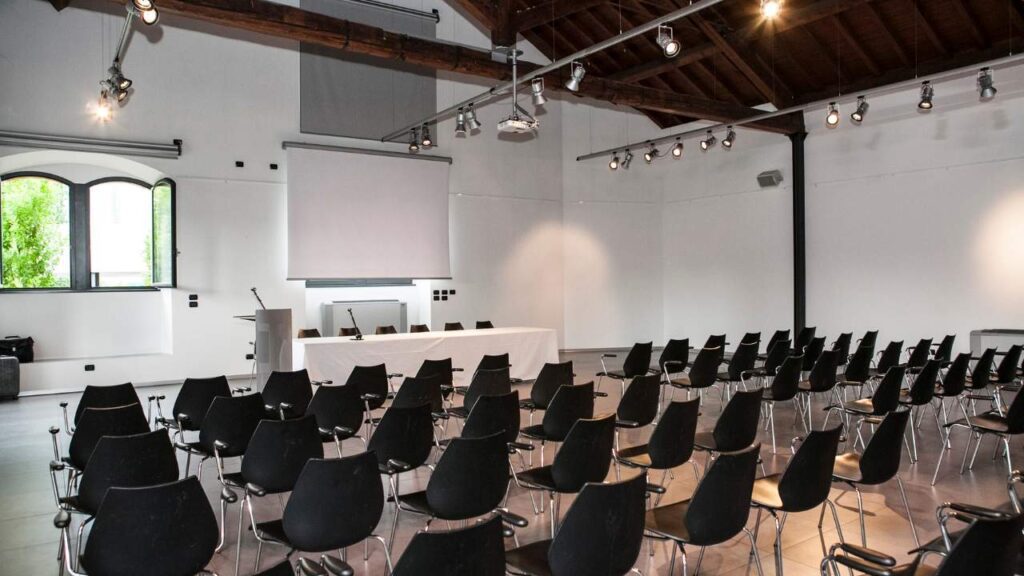 Modern conference venue in Dublin with large presentation screen, rows of chairs set for delegates, and full AV setup for corporate events.