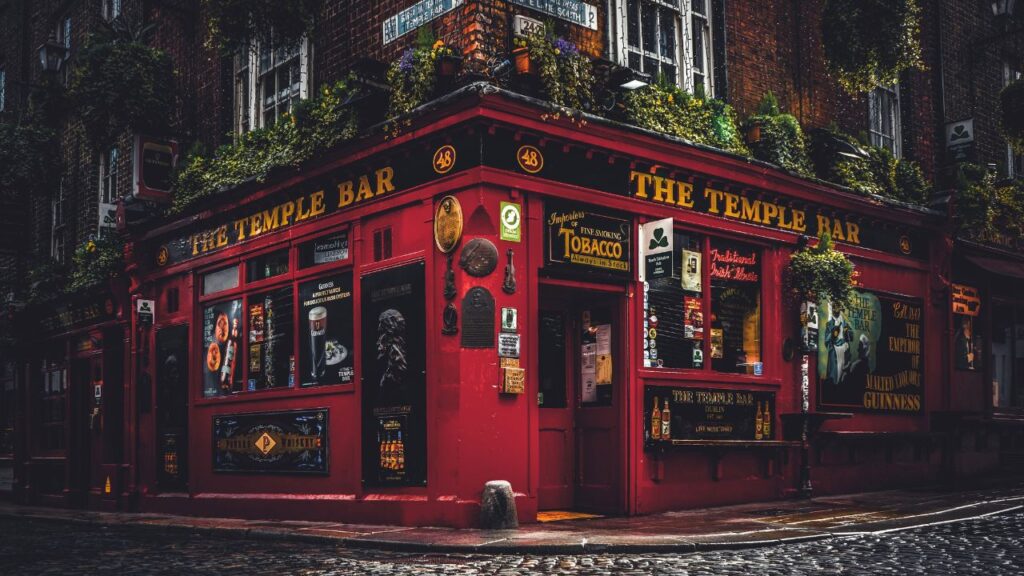 Famous Red Brick Corner Bar with lots of plants in the windows in Temple Bar, Dublin City.