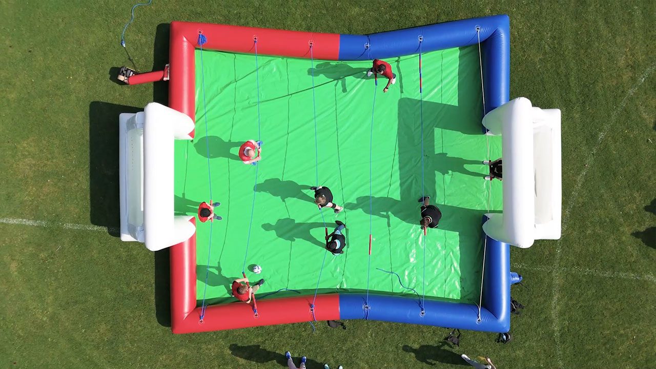 Outdoor team-building activity during corporate retreats in Ireland Corporate retreats in Ireland with inflatable football pitch for team activities