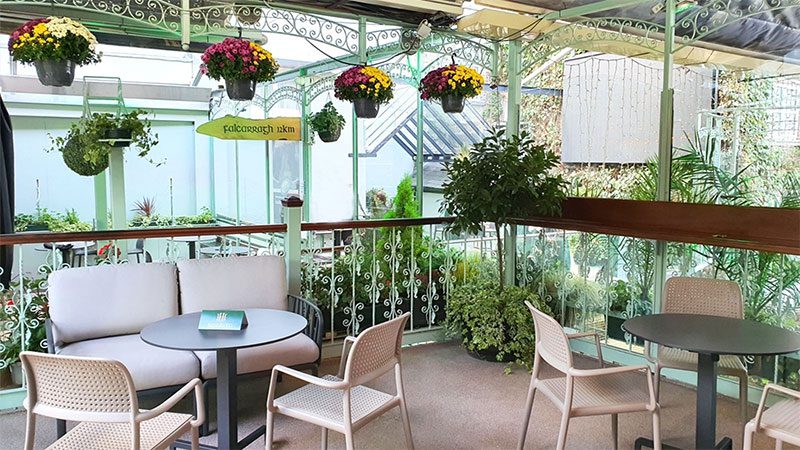 Elevated outdoor terrace with greenery at a summer party venue in Dublin Stunning elevated outdoor area with lush greenery and cosy seating at a summer party venue in Dublin