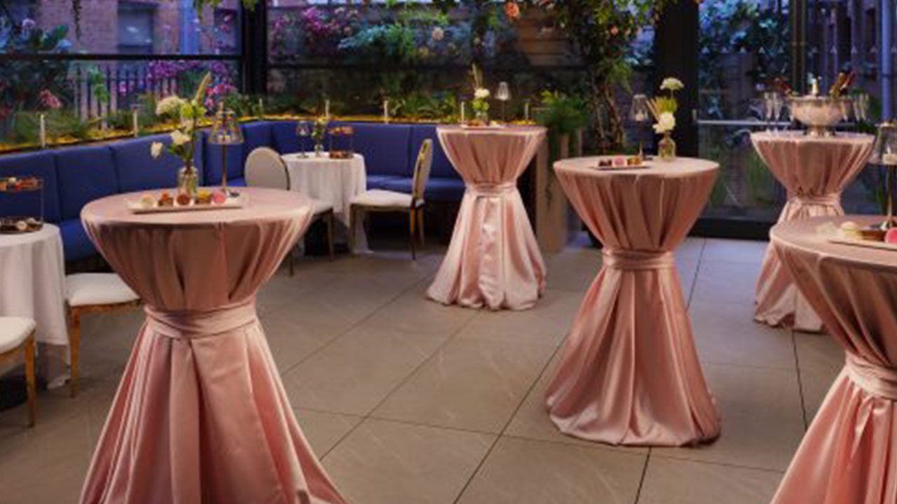 The Alex Hotel Pod Table Setup for Christmas Party Nights Festively dressed room at The Alex Hotel with pink gown-covered pod tables for Christmas party nights
