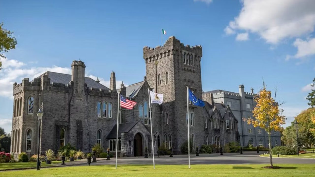 Impressive castle entrance for corporate retreats in Ireland Corporate retreats in Ireland at a castle venue with grand driveway and flagpoles