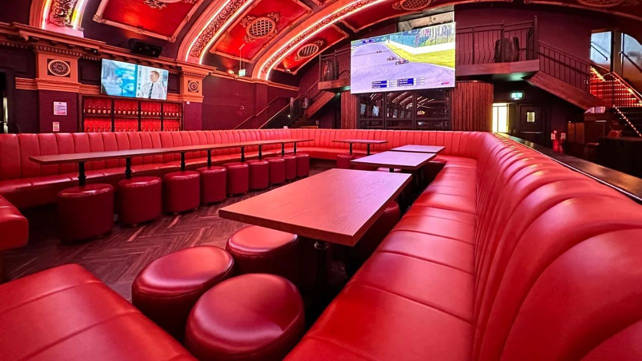 Vibrant red leather seating and big screen setup for private party venues in Dublin