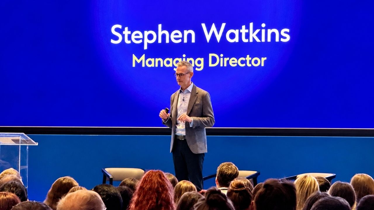 conference event featuring a live speaker in front of a packed room of people