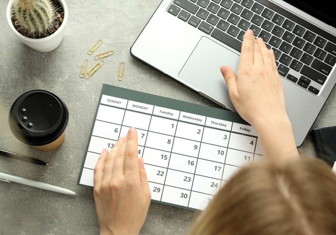 Corporate event planning in Dublin using schedule and laptop