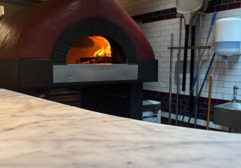 Wood fired pizza station preparing freshly made pizzas during Citco's corporate summer party at Nolita.